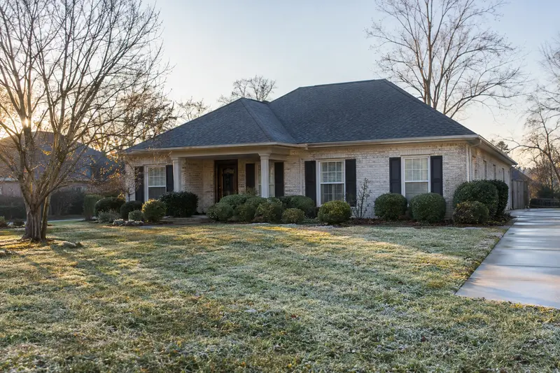 Frosted lawn in front of a tidy southern home in early winter
